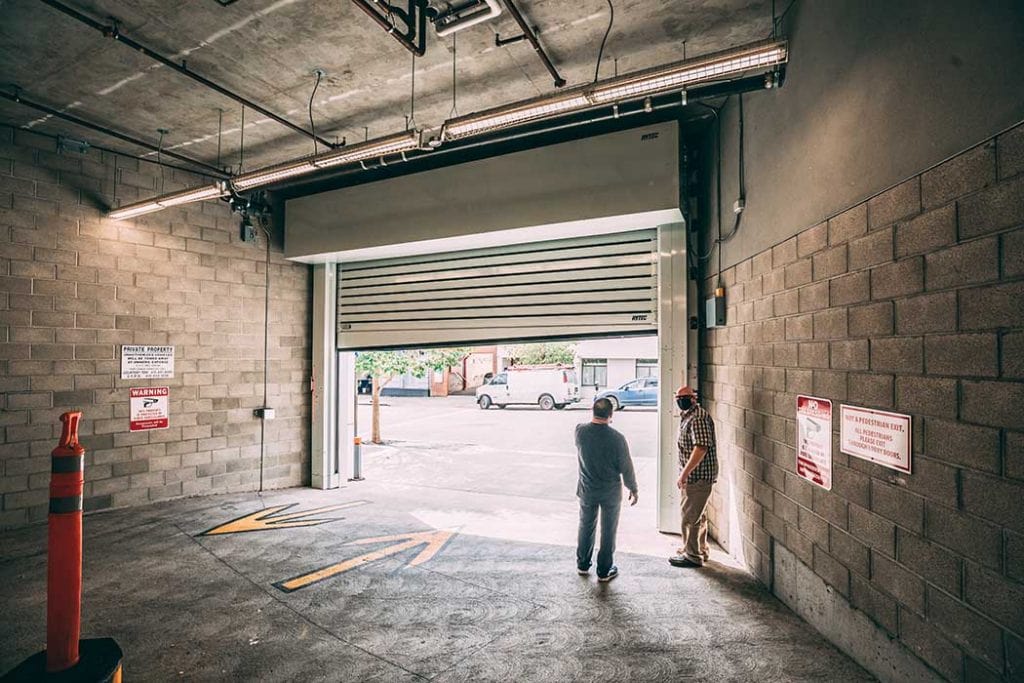 Union Door team members standing behind a newly installed overhead door